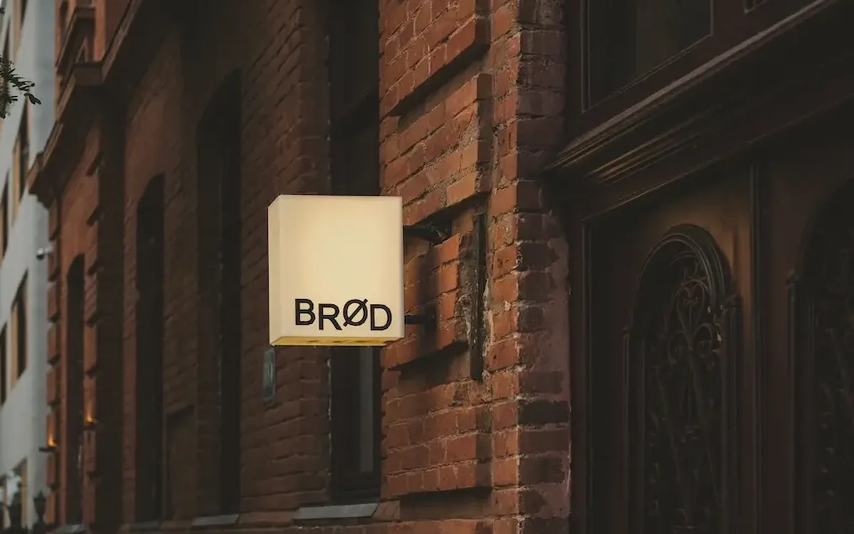 The illuminated BRØD sign on the brick facade on Ninoshvili Street